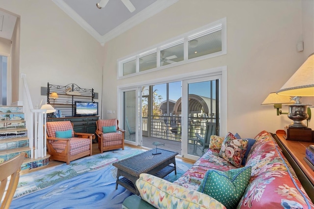 living room with hardwood / wood-style flooring, high vaulted ceiling, ceiling fan, and crown molding