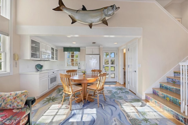 dining room with light wood-type flooring and a wealth of natural light