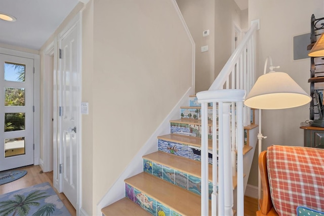 stairs featuring hardwood / wood-style floors