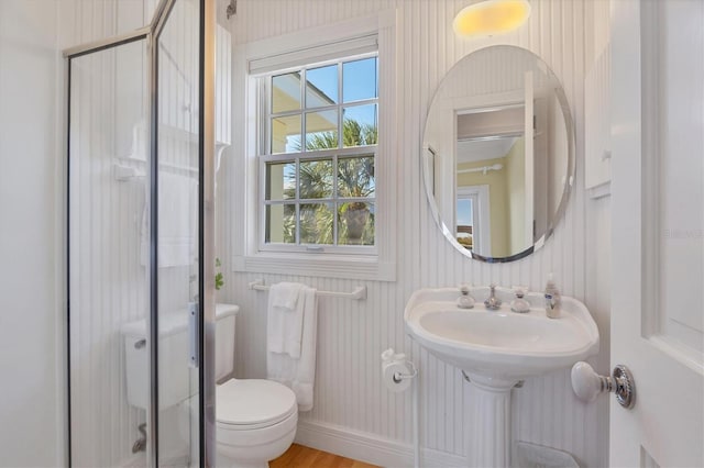 bathroom featuring toilet and wood-type flooring