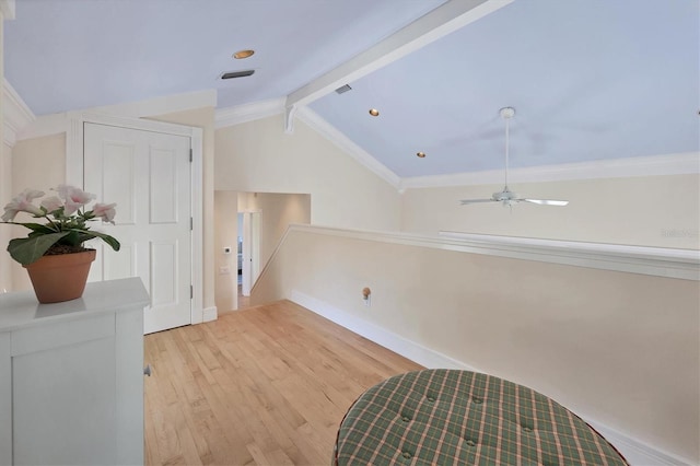 hall with lofted ceiling with beams, light wood-type flooring, and ornamental molding