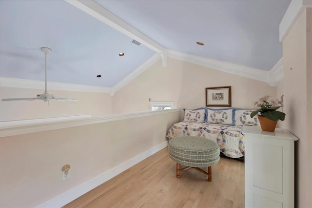 living area featuring light wood-type flooring, lofted ceiling with beams, ceiling fan, and ornamental molding