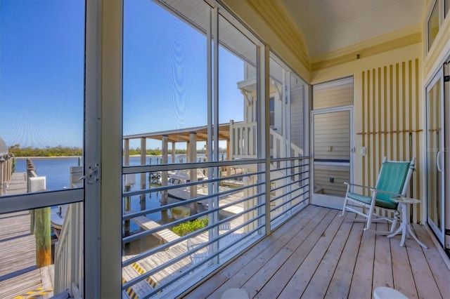 unfurnished sunroom featuring a water view