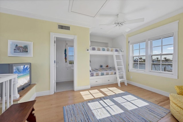 bedroom featuring ceiling fan, light wood-type flooring, and connected bathroom