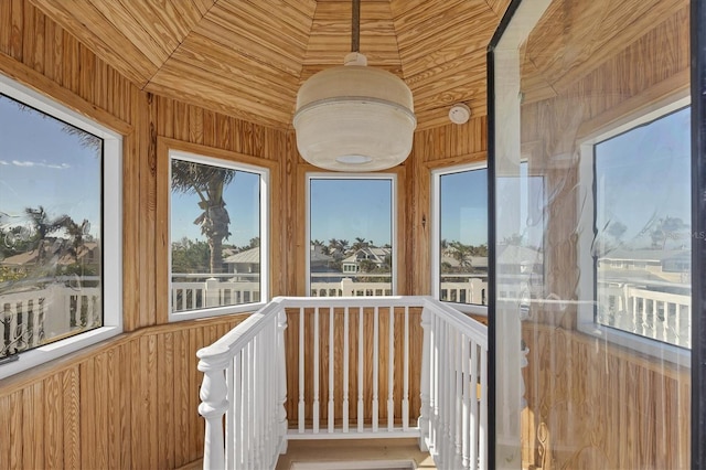 unfurnished sunroom with wooden ceiling