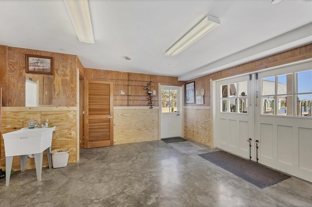 interior space featuring wood walls and concrete flooring