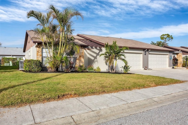 view of front of property with a front yard and a garage