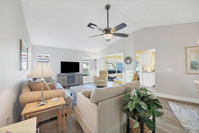 living room with ceiling fan, hardwood / wood-style floors, and lofted ceiling