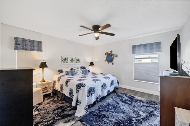 bedroom with ceiling fan and wood-type flooring