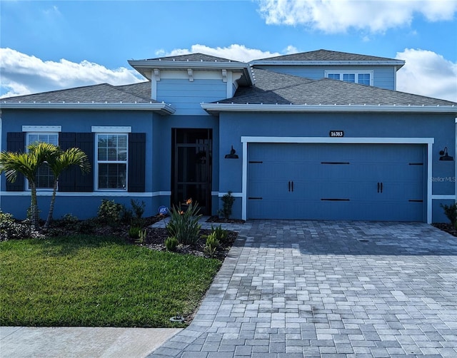 view of front of home featuring a front lawn and a garage