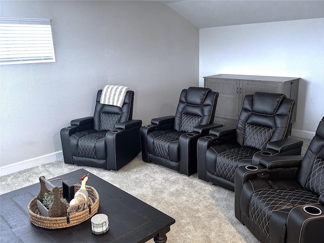 home theater room with carpet and lofted ceiling