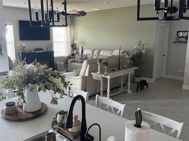 dining area with plenty of natural light, tile patterned flooring, and a notable chandelier