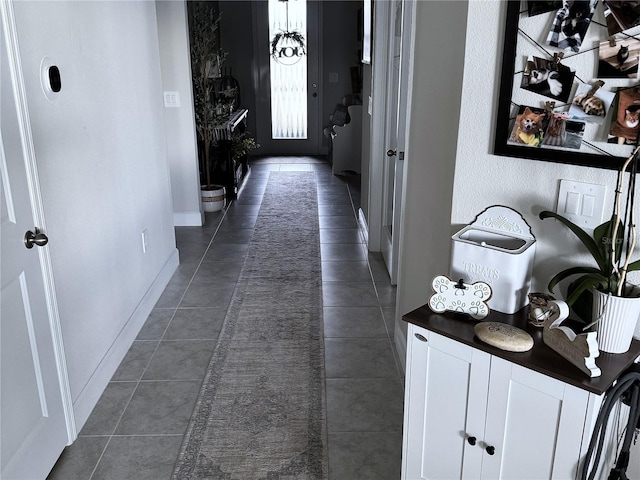 hall featuring dark tile patterned floors