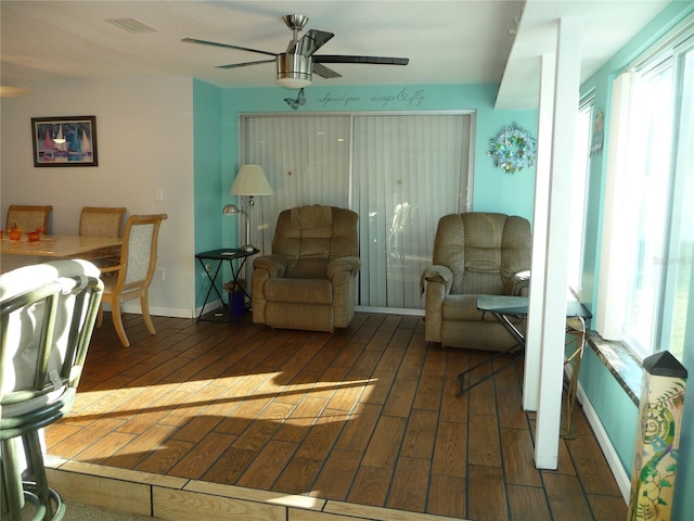 sitting room featuring dark hardwood / wood-style floors, plenty of natural light, and ceiling fan