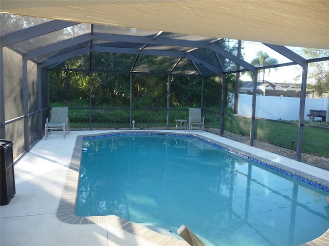 view of swimming pool with a lanai and a patio