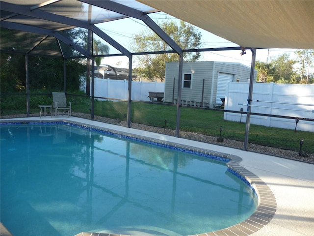 view of pool featuring a storage unit, a patio area, a lanai, and a yard