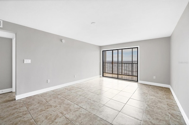 unfurnished room with light tile patterned floors