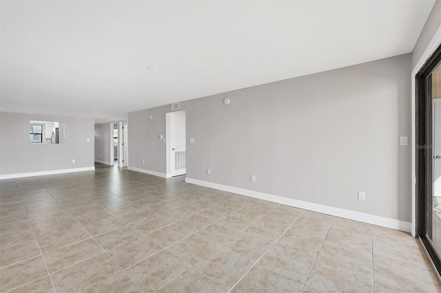 unfurnished room featuring light tile patterned flooring