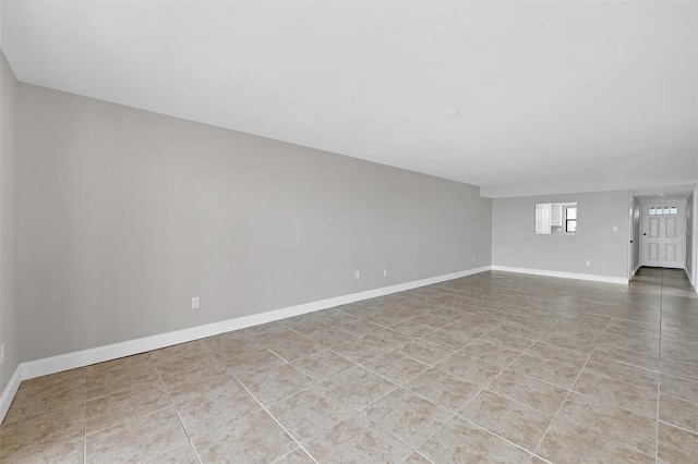 unfurnished room with light tile patterned floors