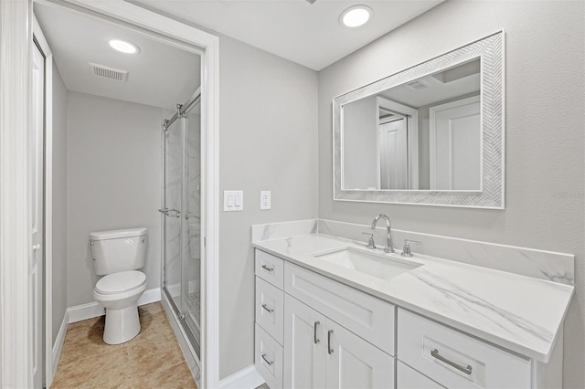 bathroom with tile patterned flooring, vanity, toilet, and a shower with shower door