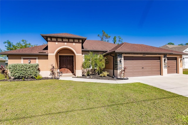 view of front facade featuring a front lawn and a garage