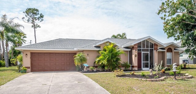 97 Mariner Ln, Rotonda West, FL 33947 - view of front facade featuring a garage, concrete driveway, a front yard, and stucco siding
