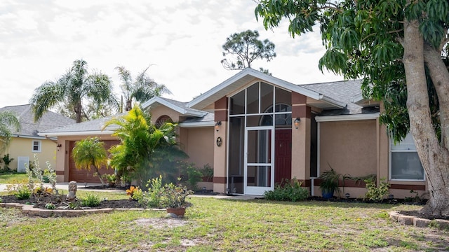 97 Mariner Ln, Rotonda West, FL 33947 - view of front facade with stucco siding, an attached garage, a front lawn, roof with shingles, and a sunroom