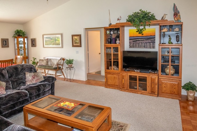 living room with lofted ceiling and parquet floors