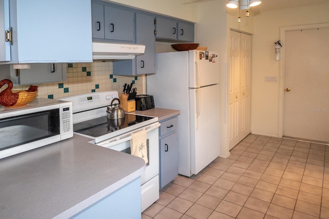 kitchen with light tile patterned flooring, white appliances, and tasteful backsplash