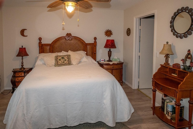 bedroom with ceiling fan and light hardwood / wood-style flooring