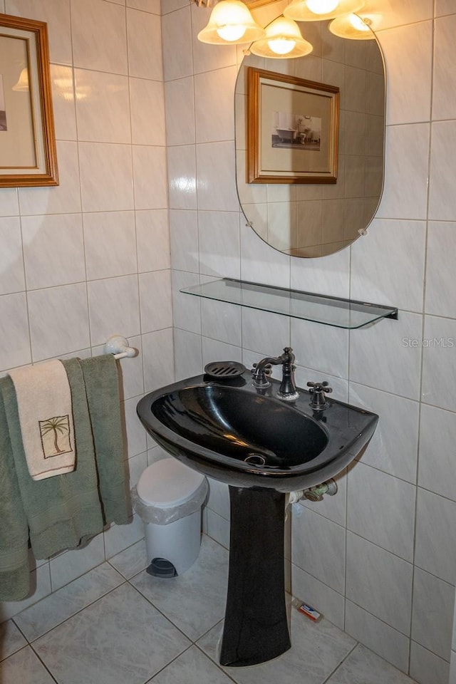 bathroom with backsplash, tile patterned flooring, tile walls, and sink