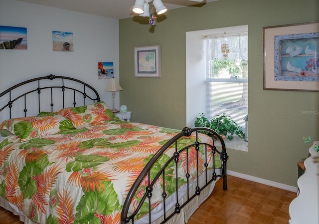 bedroom featuring ceiling fan and parquet floors