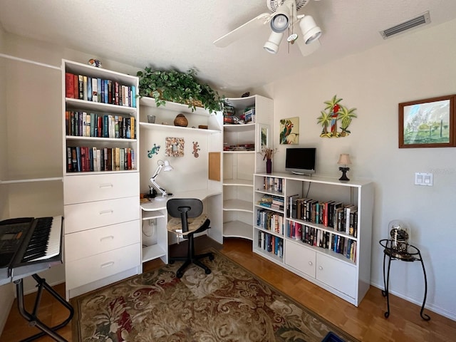 office space with dark hardwood / wood-style floors and ceiling fan