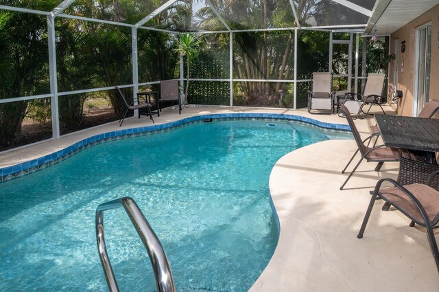 97 Mariner Ln, Rotonda West, FL 33947 - swimming pool featuring glass enclosure and a patio
