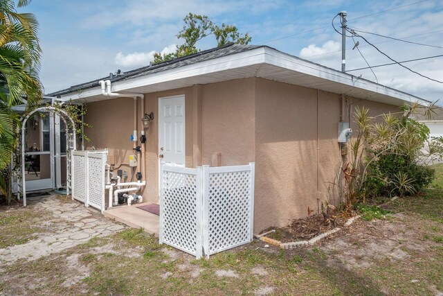 97 Mariner Ln, Rotonda West, FL 33947 - view of side of home with stucco siding