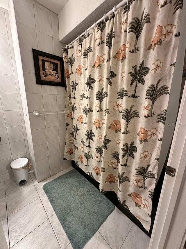 bathroom featuring tile patterned flooring, tile walls, and a shower with shower curtain