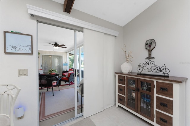 doorway to outside with ceiling fan and light tile patterned flooring