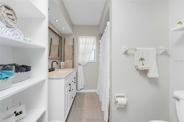 bathroom featuring tile patterned floors, vanity, and toilet