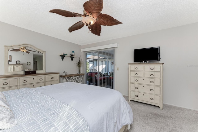 carpeted bedroom featuring access to outside, ceiling fan, and a textured ceiling