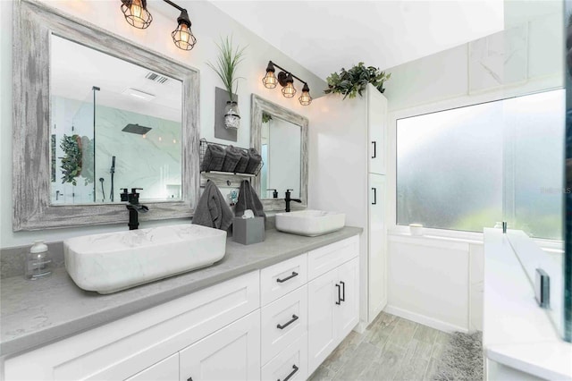 bathroom featuring hardwood / wood-style floors, vanity, and an enclosed shower