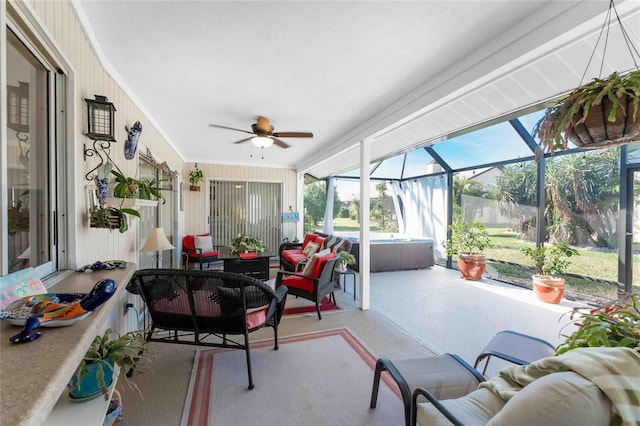 sunroom / solarium featuring ceiling fan