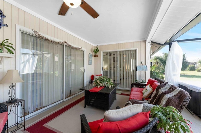 sunroom / solarium featuring ceiling fan