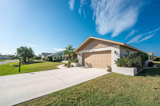 ranch-style house with a garage and a front lawn