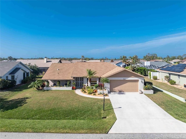 ranch-style home with a garage and a front lawn