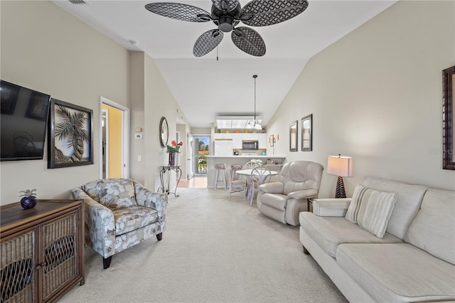 carpeted living room featuring ceiling fan and high vaulted ceiling