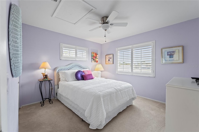 carpeted bedroom with multiple windows and ceiling fan