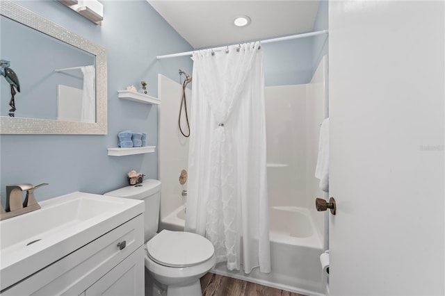 full bathroom with hardwood / wood-style flooring, shower / bath combination with curtain, toilet, and vanity