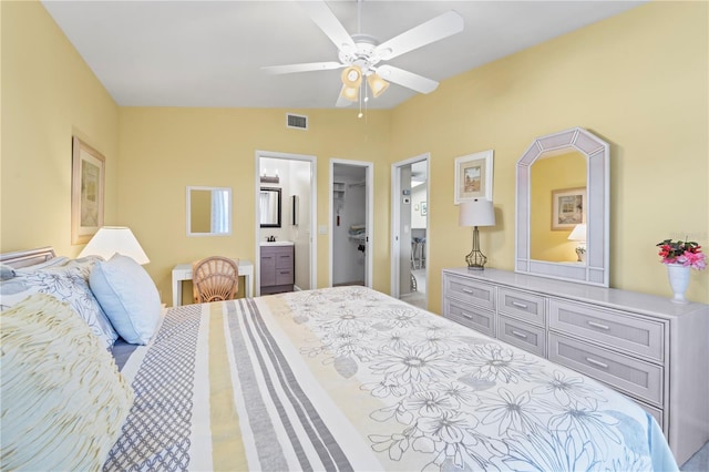 bedroom featuring ensuite bath, ceiling fan, sink, a walk in closet, and a closet