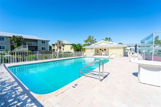 view of swimming pool with a patio