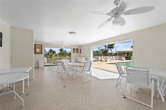 view of patio / terrace with ceiling fan and a community pool